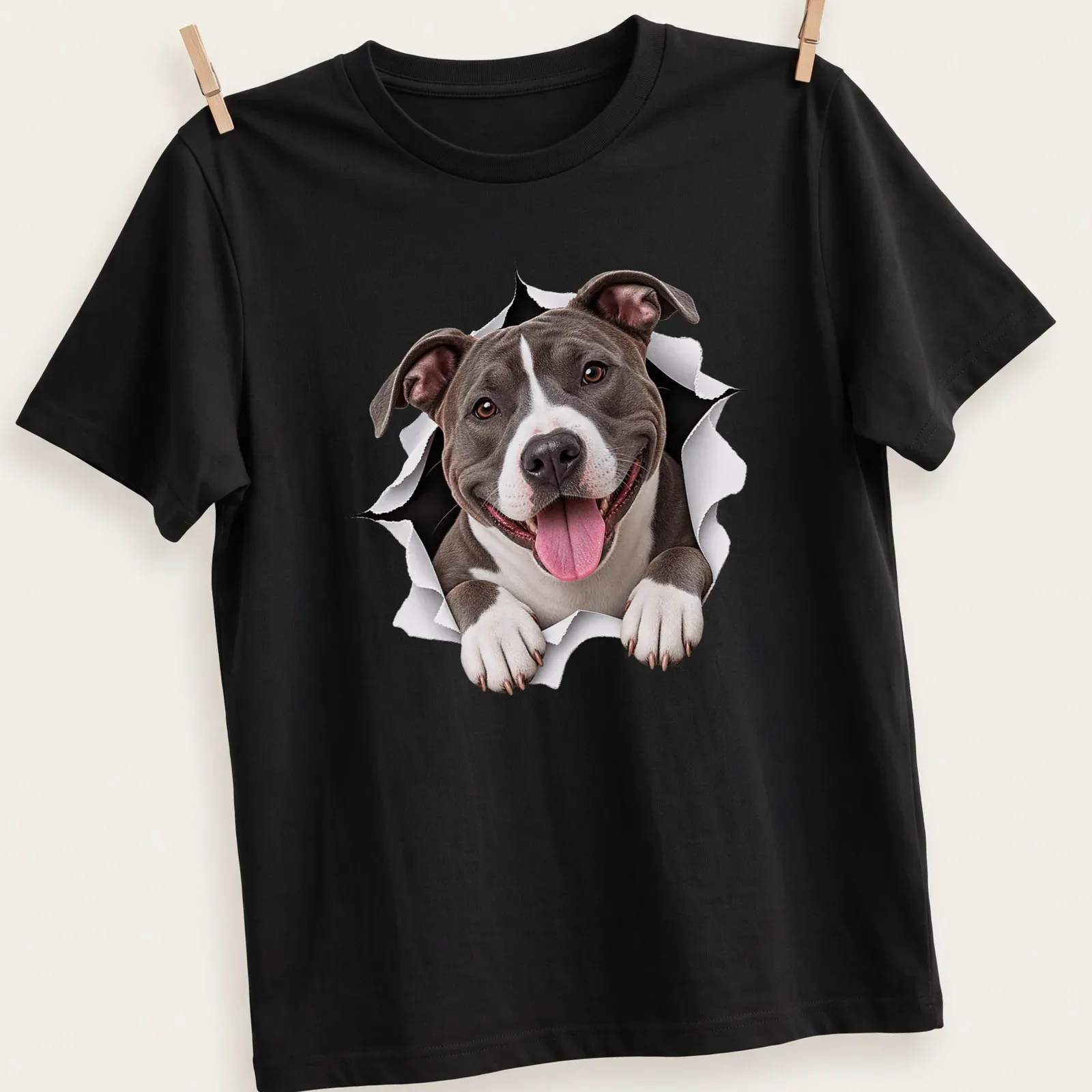 Realistic print of an American Staffordshire Terrier with a playful expression in gray, white, and black. — printed on a unisex t-shirt