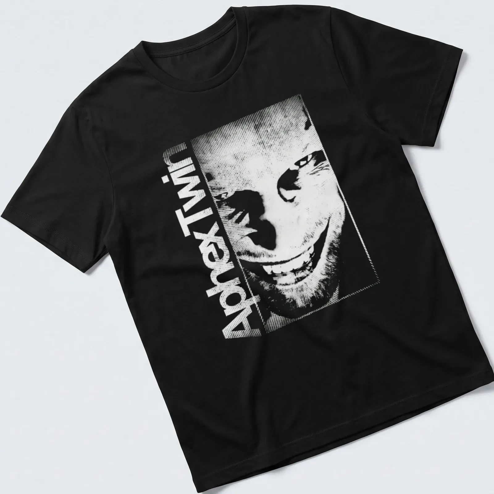 Minimalist Aphex Twin album tee with bold black text on white background — printed on a unisex t-shirt