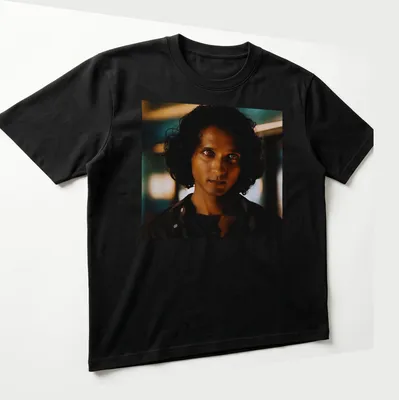 Dramatic portrait of Armand in dark hues with blue and gold accents — printed on a unisex t-shirt (angled view)