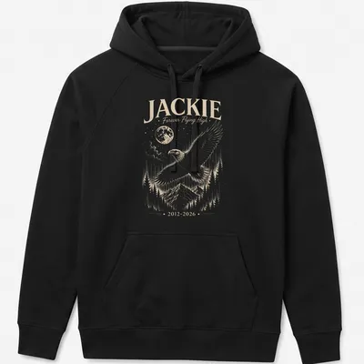 Detailed illustration of a bald eagle with the text Jackie Forever Flying High 2012 2026 — printed on a unisex hoodie