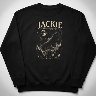 Detailed illustration of a bald eagle with the text Jackie Forever Flying High 2012 2026 — printed on a unisex sweatshirt