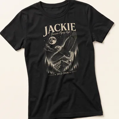 Detailed illustration of a bald eagle with the text Jackie Forever Flying High 2012 2026 — printed on a women's shirt
