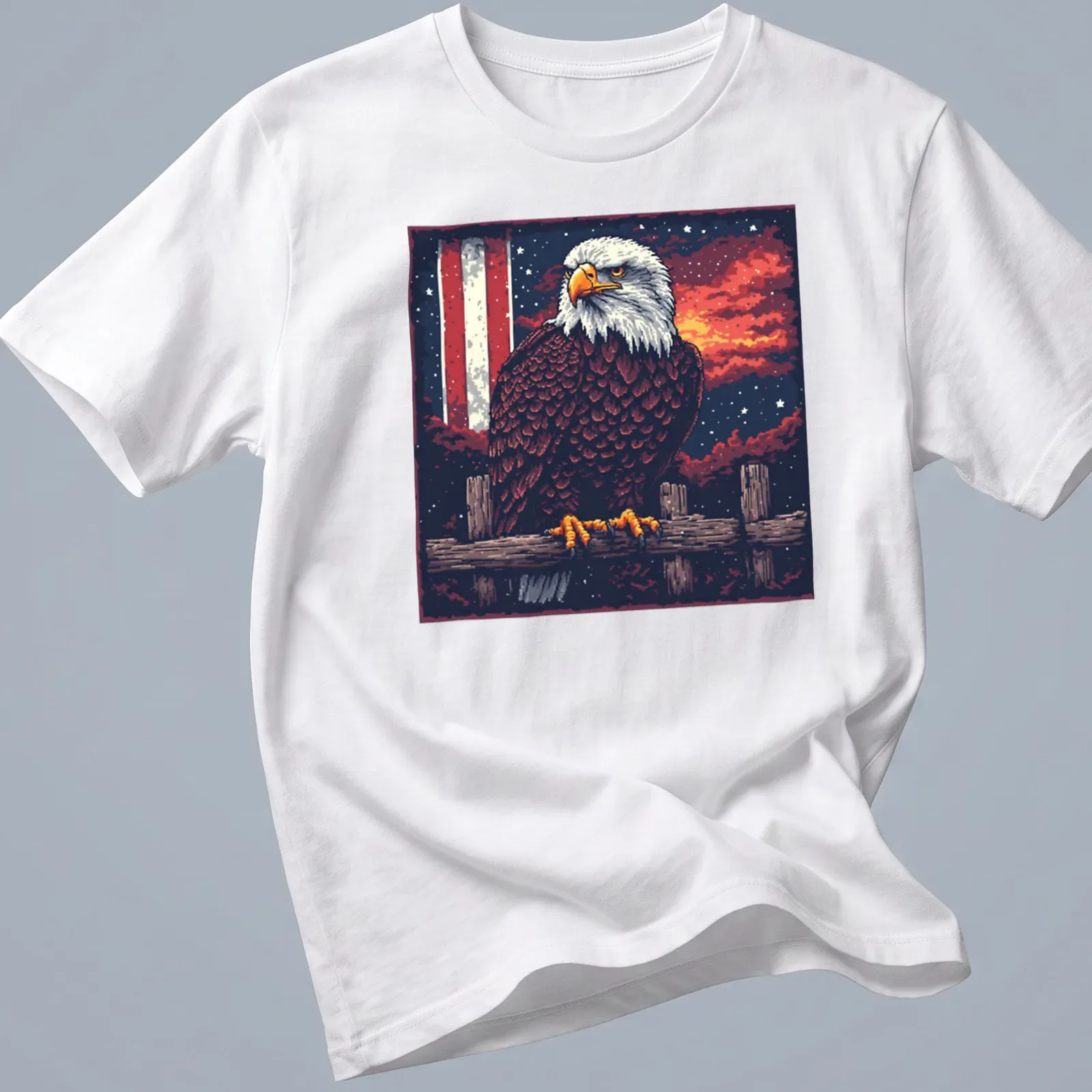 Retro pixel art of a bald eagle against a sunset background — printed on a unisex t-shirt