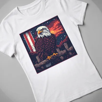 Retro pixel art of a bald eagle against a sunset background — printed on a women's shirt