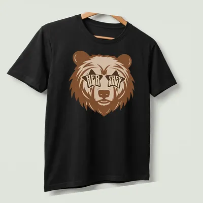 Playful bear wearing star sunglasses with retro text 'HER SHEY' above — printed on a unisex t-shirt (angled view)