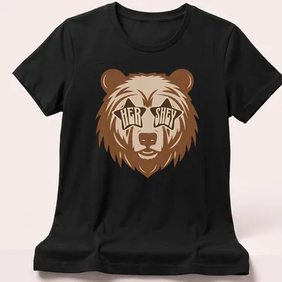 Playful bear wearing star sunglasses with retro text 'HER SHEY' above — printed on a women's shirt