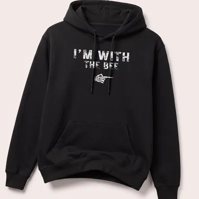 Playful cartoon bee design with text I'm With The BEE for Halloween — printed on a unisex hoodie