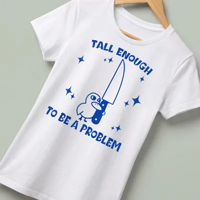 Cartoon bird holding a knife with humorous text about height issues — printed on a women's shirt