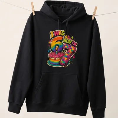 Colorful birthday cake design with text I Was 6 Now I'm 7 — printed on a unisex hoodie
