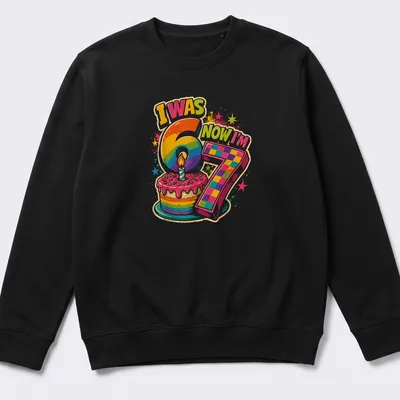 Colorful birthday cake design with text I Was 6 Now I'm 7 — printed on a unisex sweatshirt