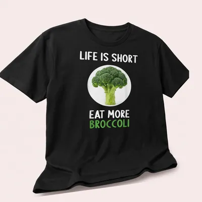 Modern shirt with a clean design featuring broccoli and humorous text about eating more vegetables — printed on a unisex t-shirt (angled view)