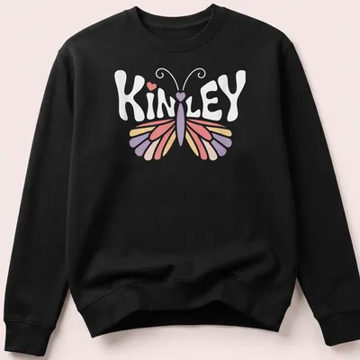 Vintage t-shirt with the name Kinley and a butterfly design in pastel colors — printed on a unisex sweatshirt