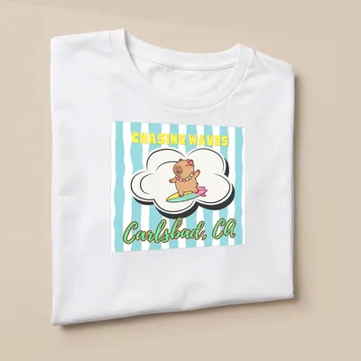 Cute cartoon capybara surfing with cheerful colors and text — printed on a unisex t-shirt (angled view)
