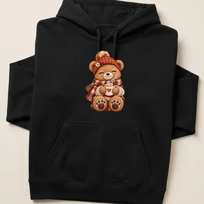 Kawaii illustration of a cozy teddy bear with coffee, featuring warm autumn colors — printed on a unisex hoodie