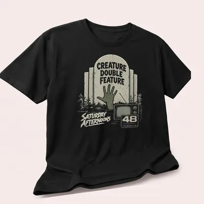 Vintage horror t-shirt featuring a zombie hand and retro television design — printed on a unisex t-shirt (angled view)
