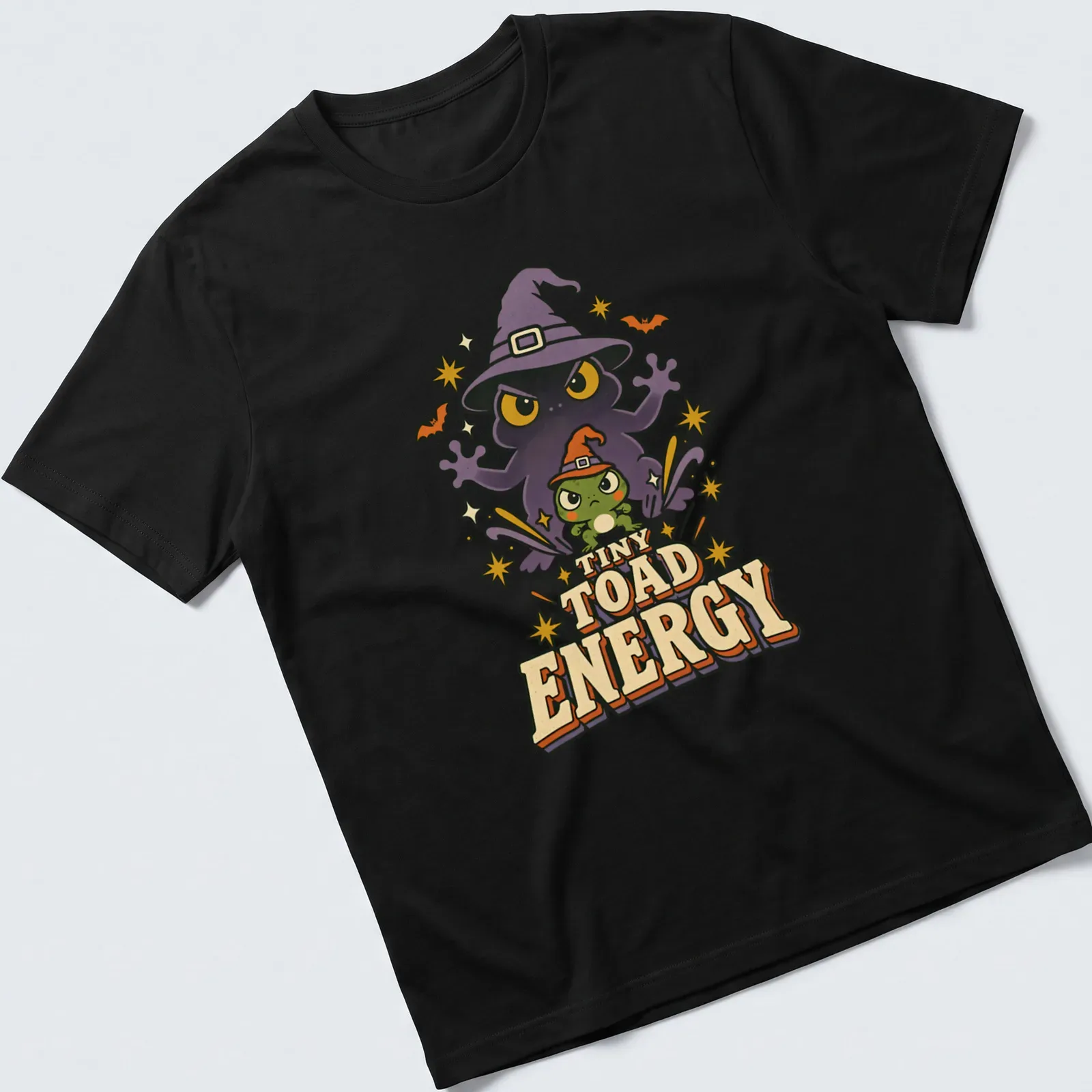 Cartoon frog witch with TINY TOAD ENERGY text in bright colors for Halloween — printed on a unisex t-shirt
