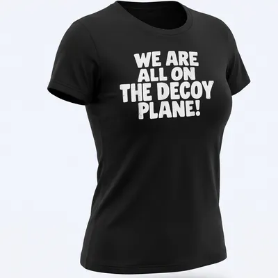 Bold typography shirt with the text 'WE ARE ALL ON THE DECOY PLANE!' — printed on a women's shirt