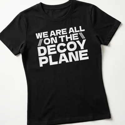 Bold typography t-shirt with the phrase We Are All On The Decoy Plane in white. — printed on a women's shirt
