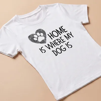 Bold typography t-shirt featuring a dog paw print and the phrase about dogs and home — printed on a women's shirt