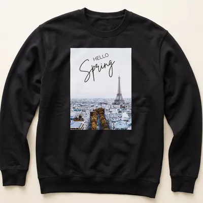 Minimalist print features the Eiffel Tower with 'HELLO Spring' text in light blue and gold — printed on a unisex sweatshirt