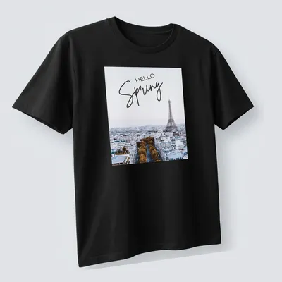 Minimalist print features the Eiffel Tower with 'HELLO Spring' text in light blue and gold — printed on a unisex t-shirt (angled view)