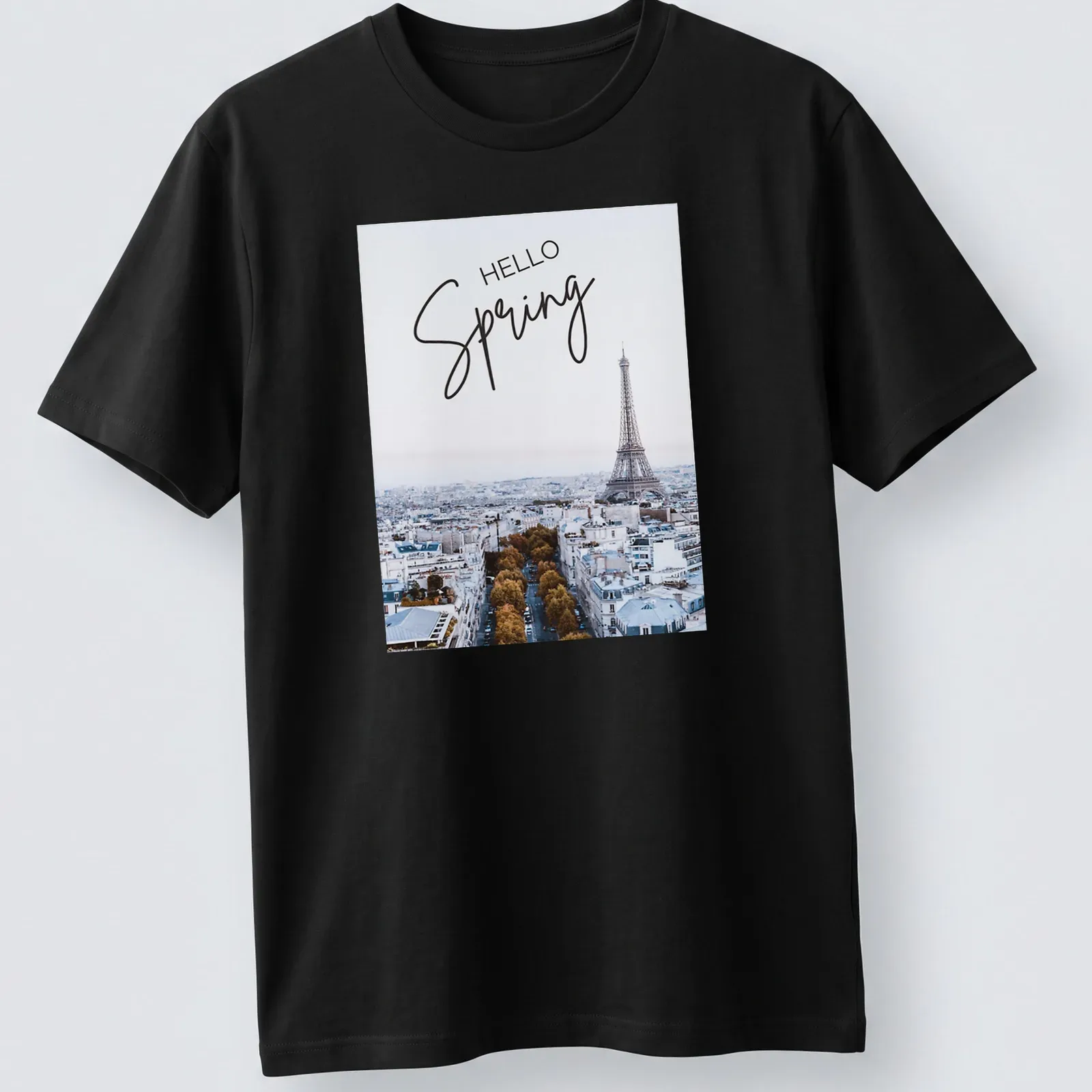 Minimalist print features the Eiffel Tower with 'HELLO Spring' text in light blue and gold — printed on a unisex t-shirt