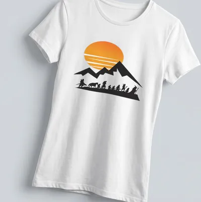 Silhouette of travelers at sunrise with mountains in the background — printed on a women's shirt