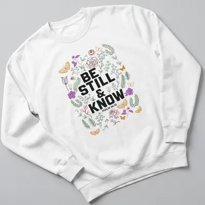 Floral design with the text 'BE STILL & KNOW PSALM 46:10' in vibrant colors — printed on a unisex sweatshirt
