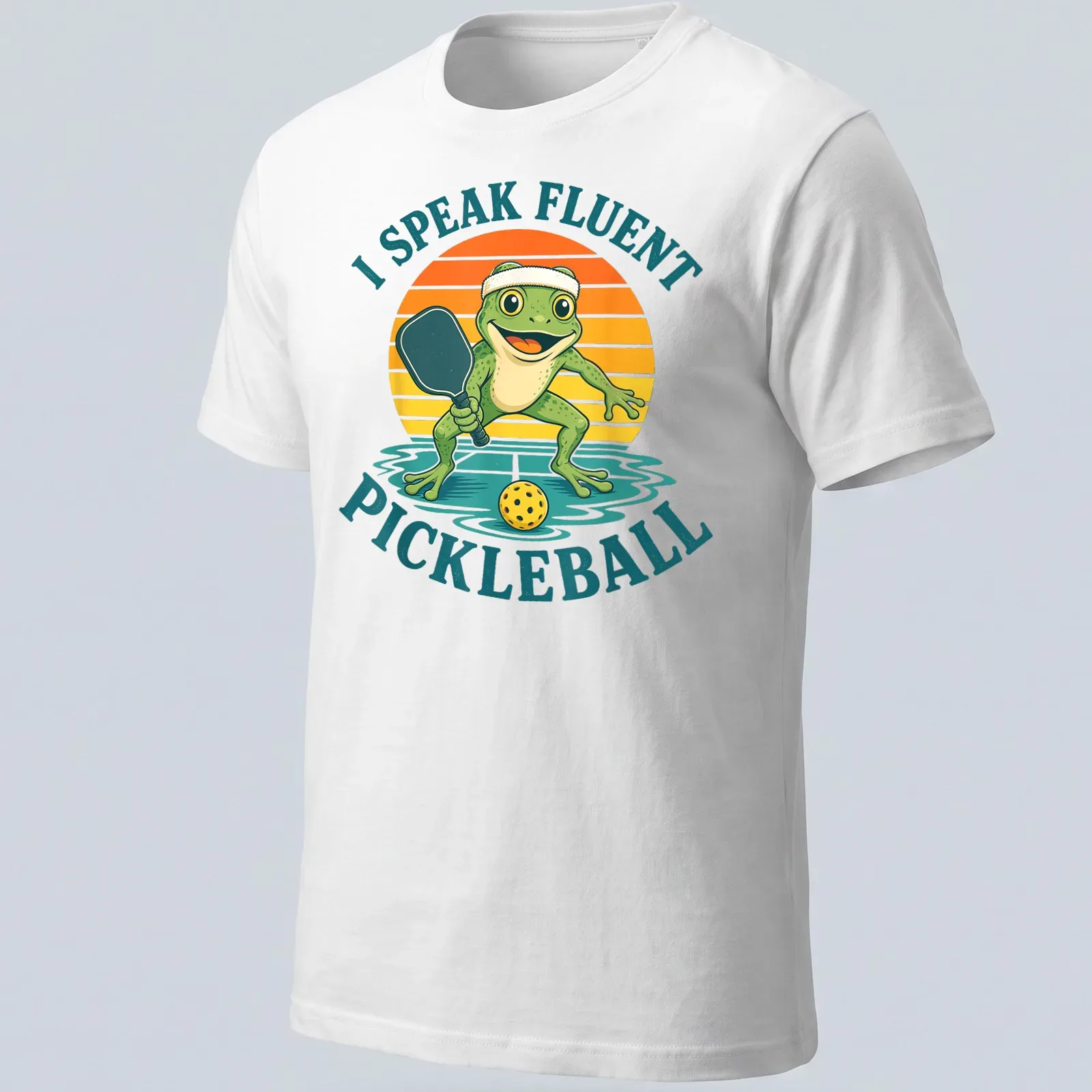 Vintage cartoon frog t-shirt featuring the phrase 'I Speak Fluent Pickleball' in colorful lettering — printed on a unisex t-shirt