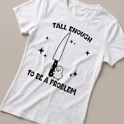 Cartoon duck holding a knife with humorous text about height problem — printed on a women's shirt