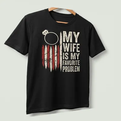 Distressed vintage T-shirt with humorous wedding ring graphic and text about marriage problems — printed on a unisex t-shirt (angled view)