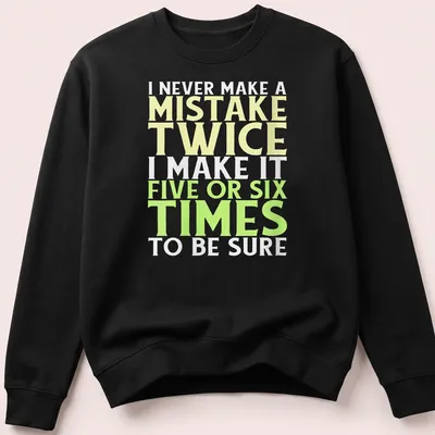 Bold typography t-shirt with funny mistake quote in yellow, green, and white — printed on a unisex sweatshirt