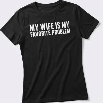 Funny typography shirt with the phrase 'MY WIFE IS MY FAVORITE PROBLEM' in bold text — printed on a women's shirt