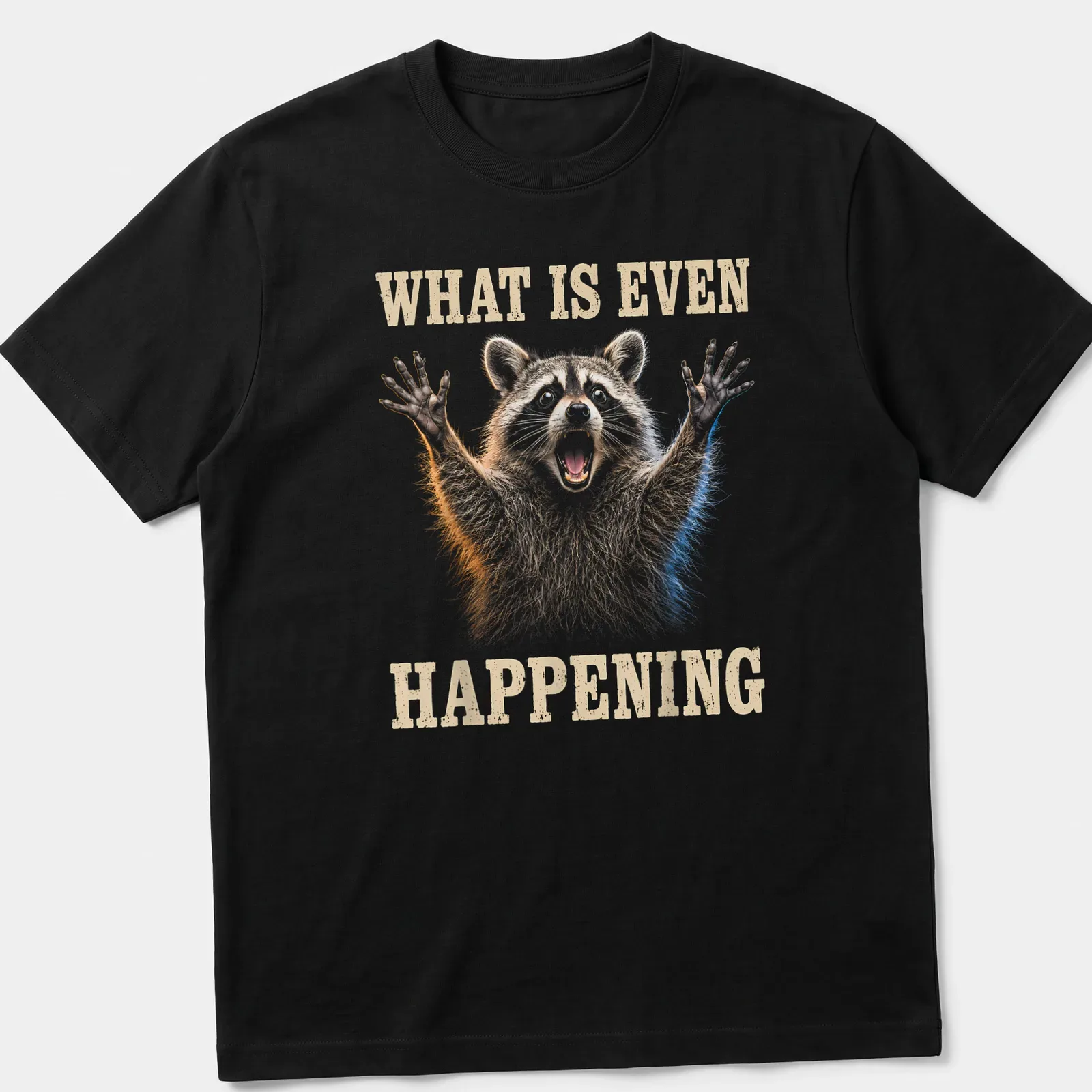 Realistic illustration of a yelling raccoon with humorous text 'What Is Even Happening' — printed on a unisex t-shirt