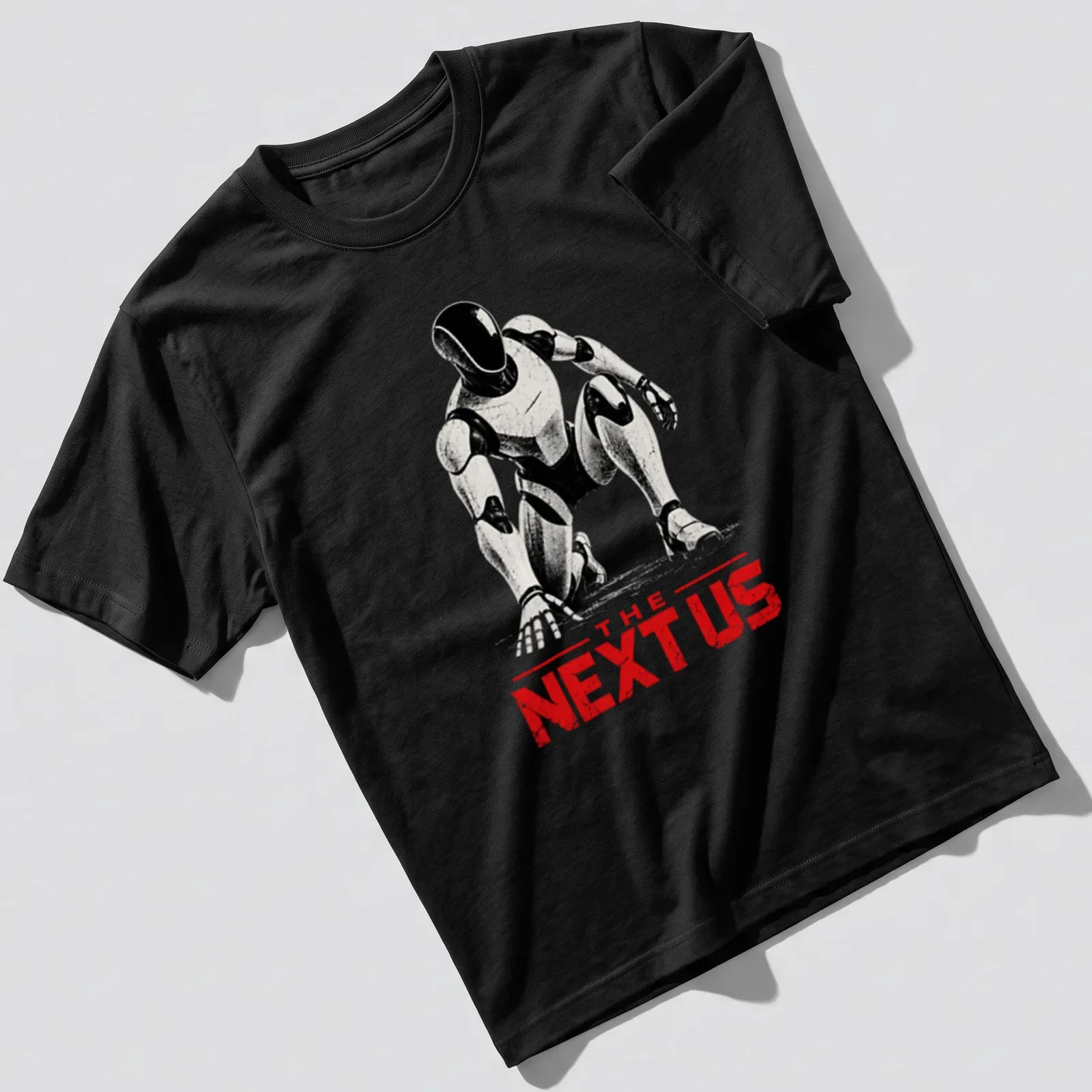 Silhouette of a futuristic android robot with the phrase 'THE NEXT US' in bold lettering — printed on a unisex t-shirt