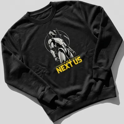 Futuristic humanoid robot silhouette with 'THE NEXT US' text in black, white, and yellow — printed on a unisex sweatshirt