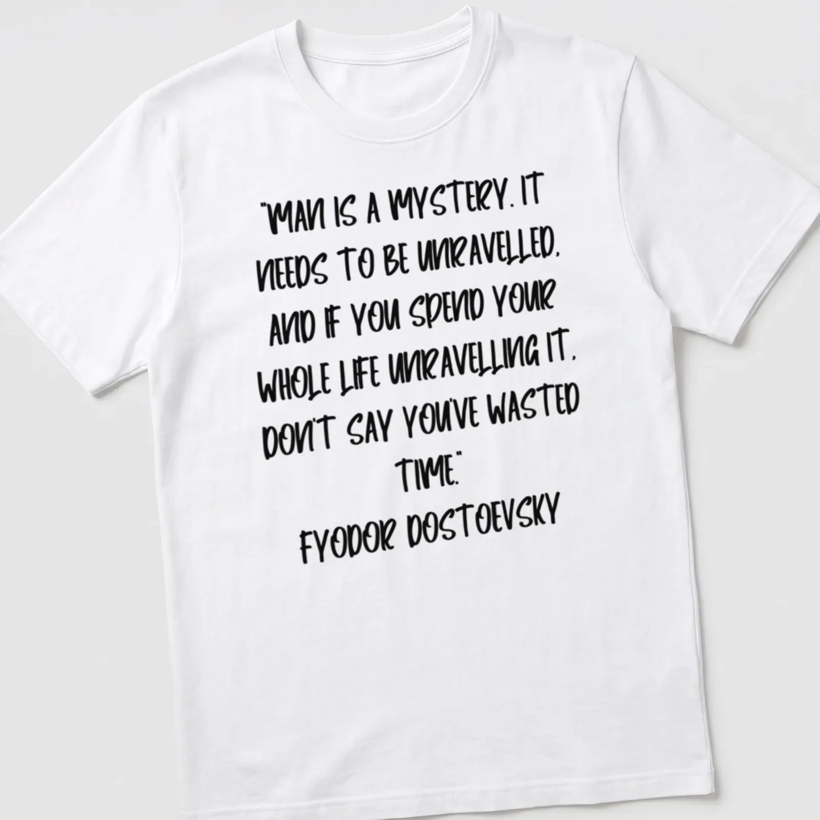 Modern handwritten Dostoevsky quote t-shirt in black on white background — printed on a unisex t-shirt
