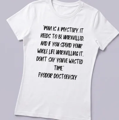 Modern handwritten Dostoevsky quote t-shirt in black on white background — printed on a women's shirt