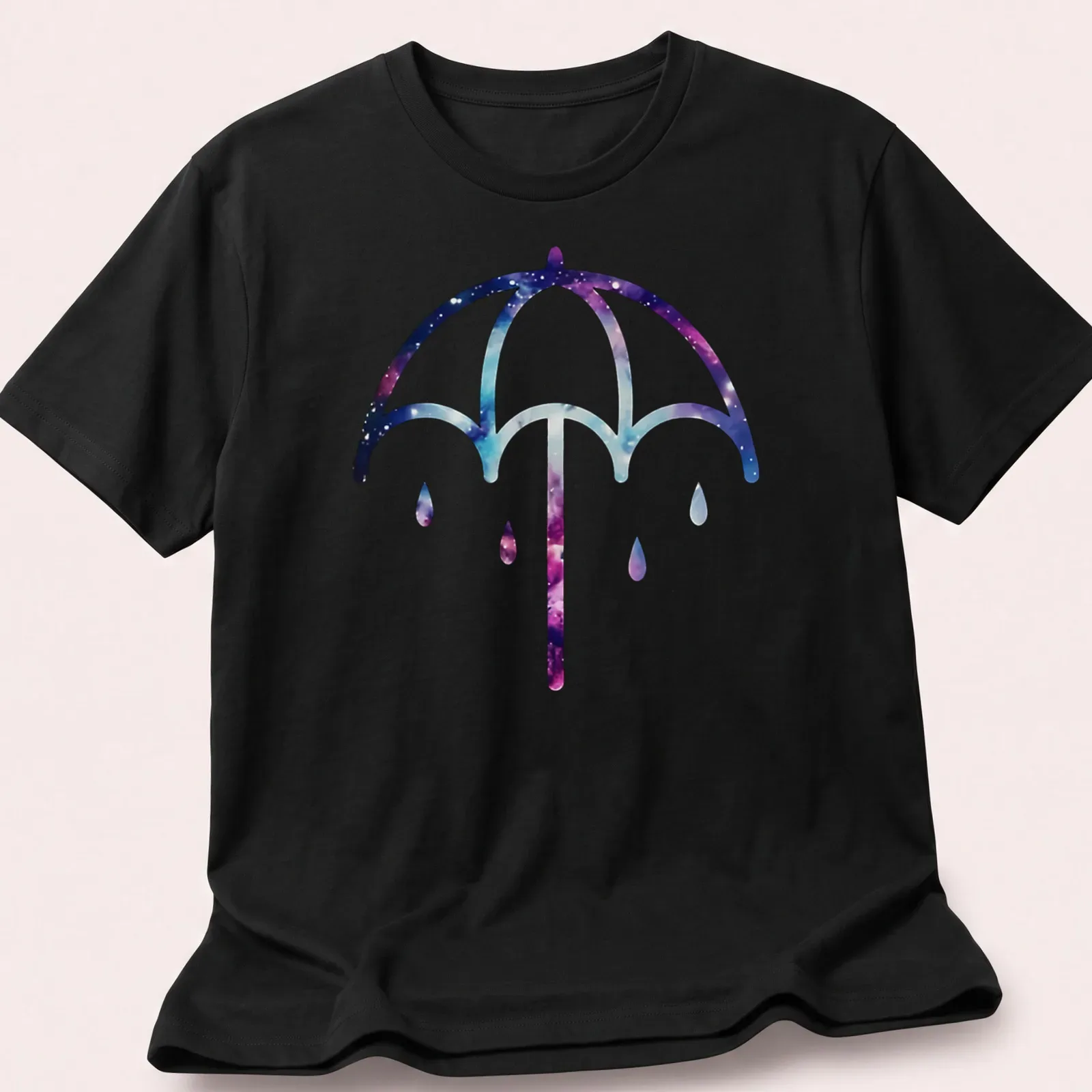 Illustration of a purple umbrella on a cosmic galaxy background in purple, blue, pink, and white — printed on a unisex t-shirt