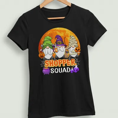 Cartoon gnomes surrounding the word 'SHOPPER' in vibrant Halloween colors — printed on a women's shirt