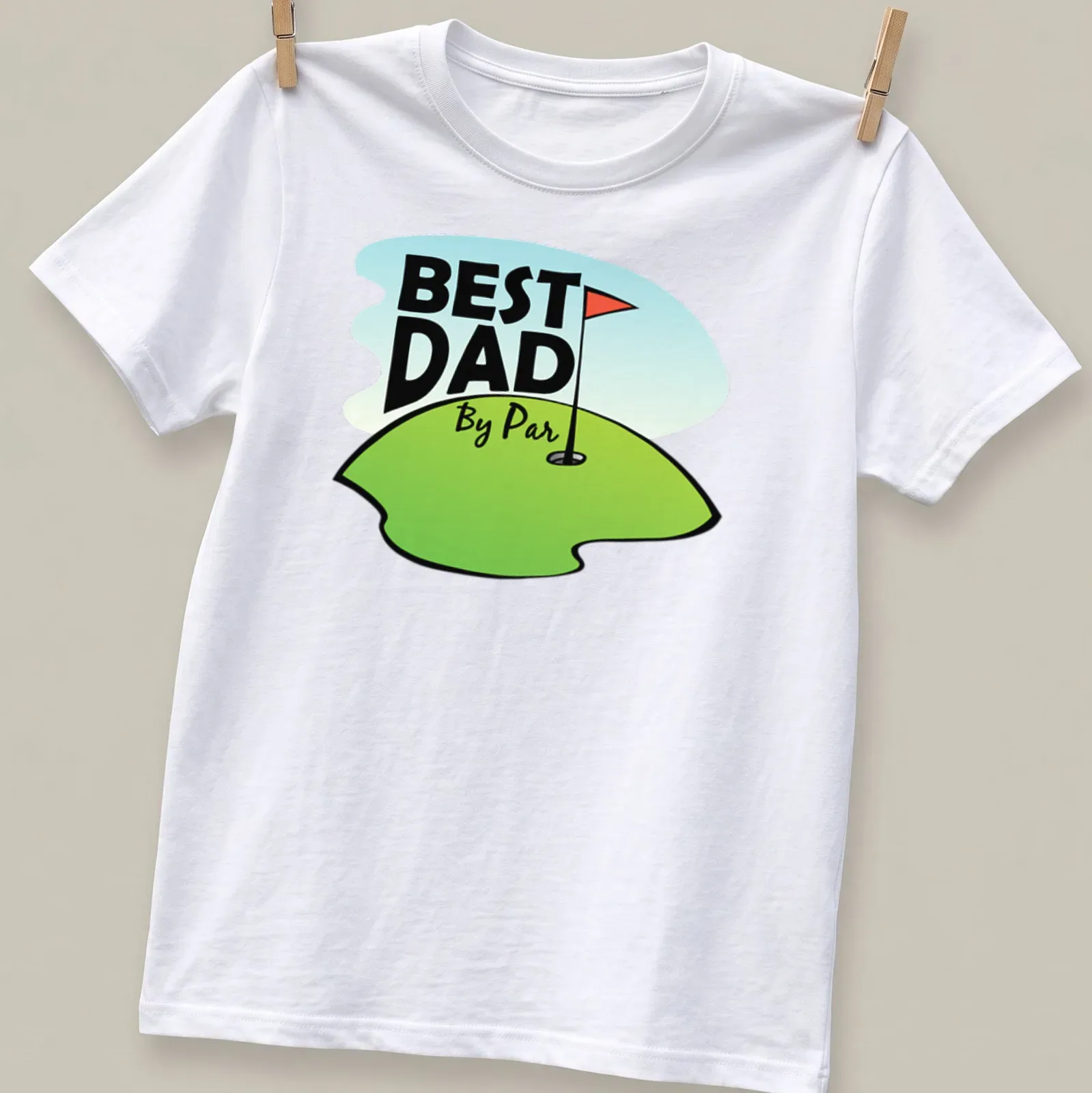 Cartoon design featuring a golf hole with a flag and text reading Best Dad By Par — printed on a unisex t-shirt