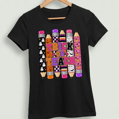 Halloween-themed t-shirt with colorful pencils and Trick or Teach text. — printed on a women's shirt