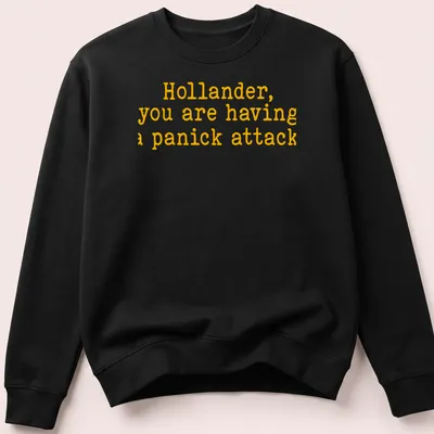 Bold yellow text on a t-shirt reads 'Hollander, you are having a panick attack' in playful typography — printed on a unisex sweatshirt
