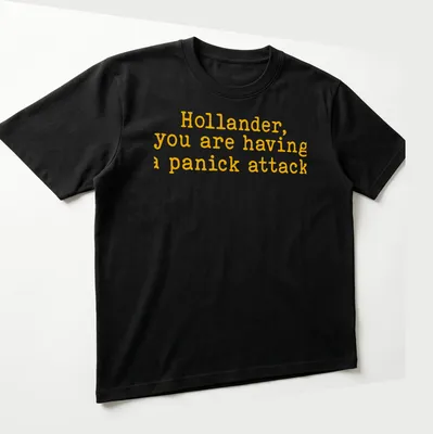 Bold yellow text on a t-shirt reads 'Hollander, you are having a panick attack' in playful typography — printed on a unisex t-shirt (angled view)