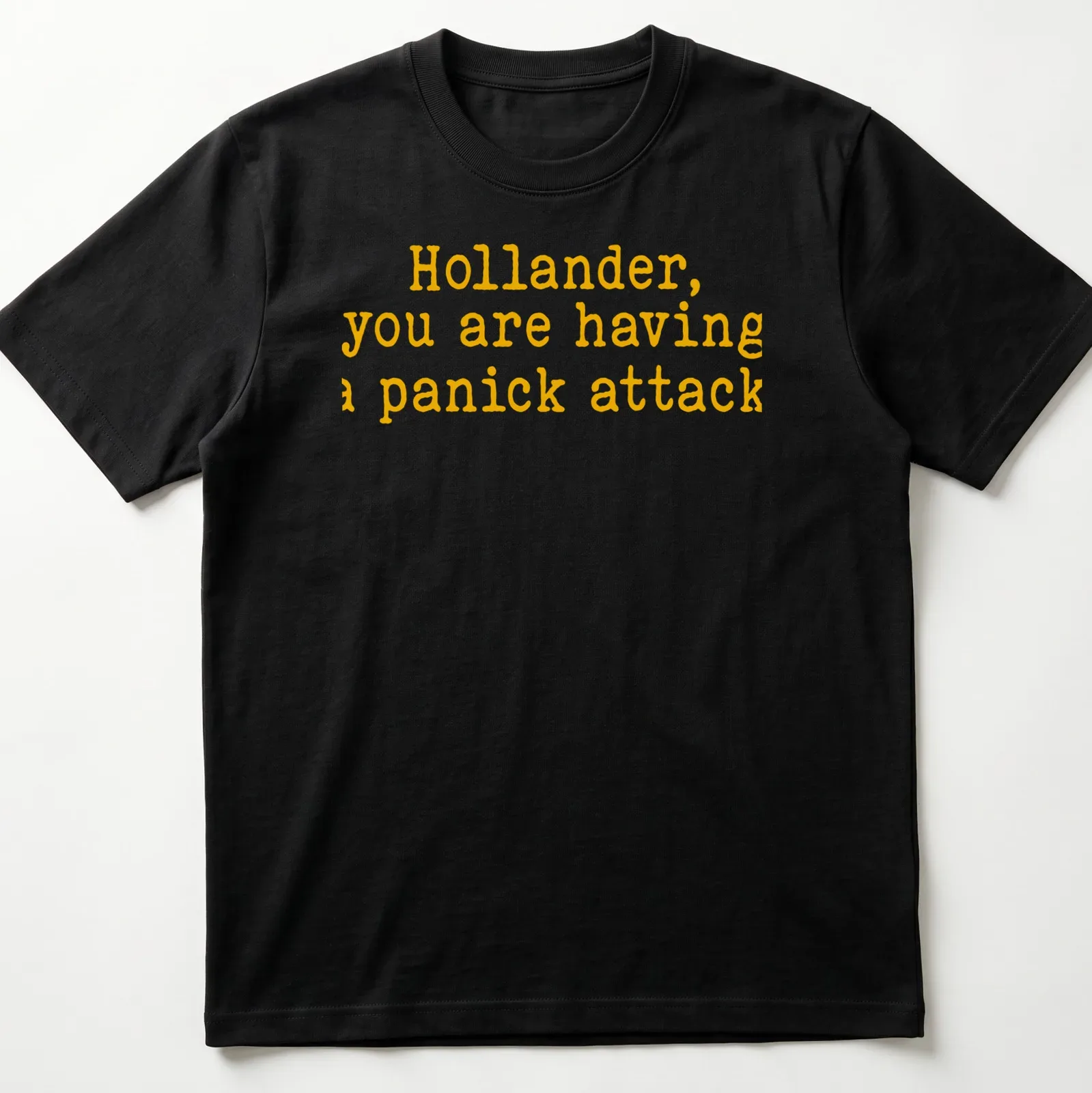 Bold yellow text on a t-shirt reads 'Hollander, you are having a panick attack' in playful typography — printed on a unisex t-shirt