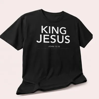 White text T-shirt featuring King Jesus John 1232 in a simple design — printed on a unisex t-shirt (angled view)
