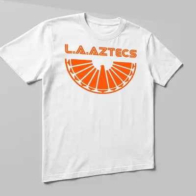 Bold geometric L.A. Aztecs soccer tee featuring an eagle emblem in orange. — printed on a unisex t-shirt (angled view)