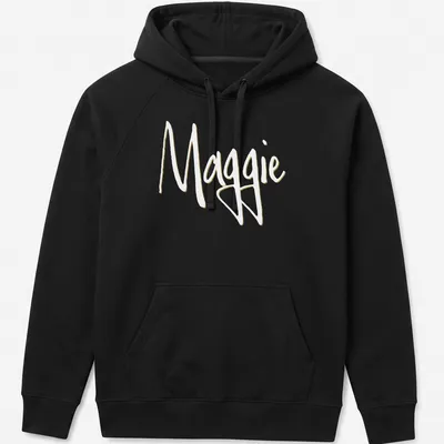 Elegant script design with the name Maggie in gold on a white background — printed on a unisex hoodie