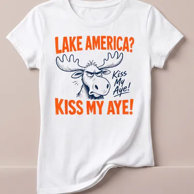 Cartoon moose with text 'LAKE AMERICA? KISS MY AYE!' in vibrant colors — printed on a women's shirt