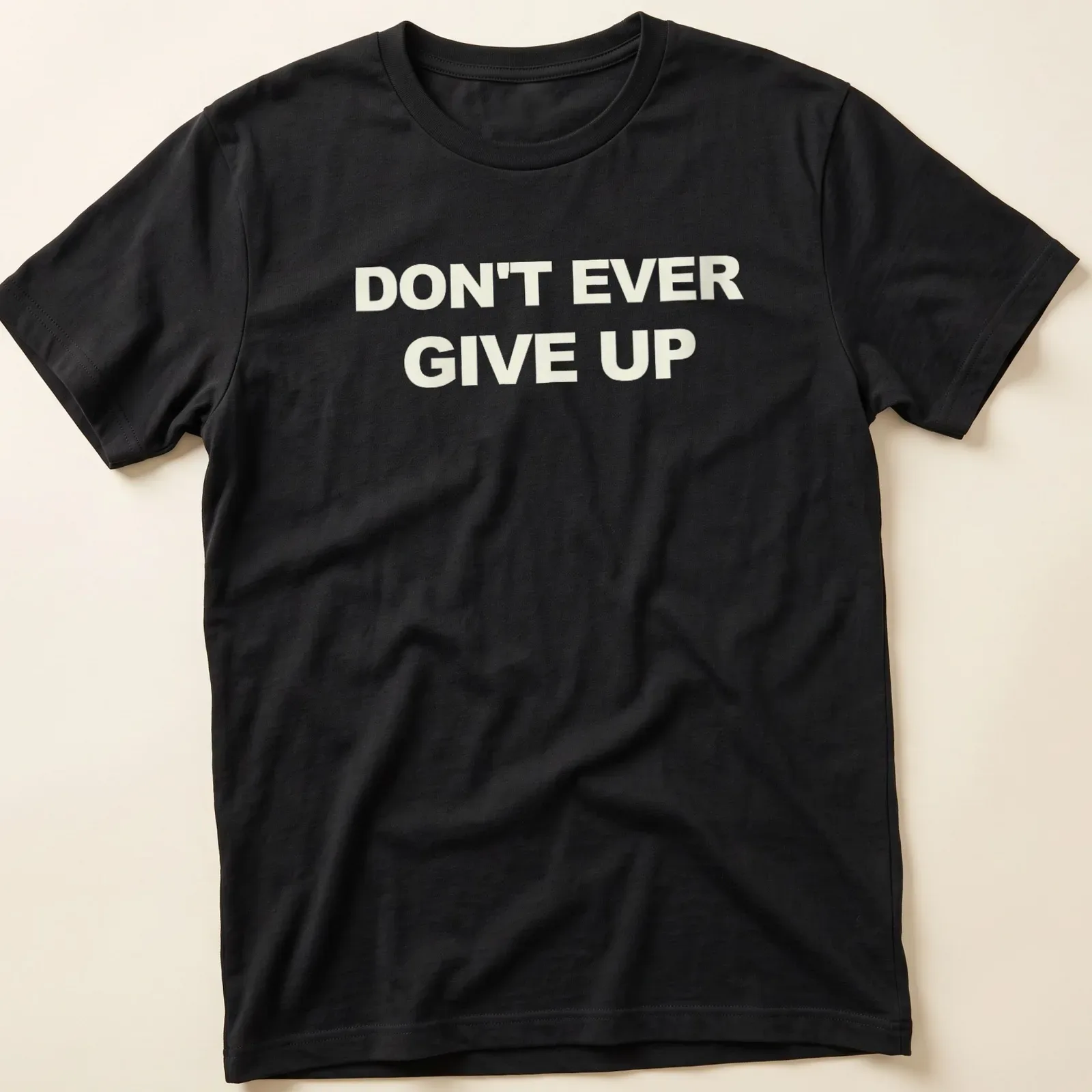 Bold typography t-shirt with the motivational phrase Don't Ever Give Up in white. — printed on a unisex t-shirt